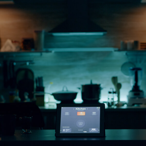 A contemporary kitchen scene with a tablet on the counter illustrating design ideas for upscale cabinets in 2025